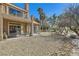 Spacious backyard with covered patio, mature trees, desert landscaping, and ample privacy at 7636 Sudan Ct, Las Vegas, NV 89149