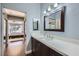 Contemporary bathroom with a single sink vanity and access to the primary bedroom at 7636 Sudan Ct, Las Vegas, NV 89149