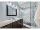 Modern primary bathroom with a glass enclosed shower, dual vanity, and updated fixtures at 7636 Sudan Ct, Las Vegas, NV 89149