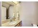 Stylish powder room with granite countertop, framed mirror and updated fixtures at 7636 Sudan Ct, Las Vegas, NV 89149