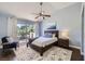 Relaxing bedroom featuring a ceiling fan, balcony, and ample natural light at 7636 Sudan Ct, Las Vegas, NV 89149