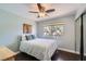 Comfortable bedroom with a bright window, ceiling fan, and ample closet space at 7636 Sudan Ct, Las Vegas, NV 89149
