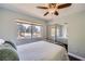 Inviting bedroom with sliding mirrored closet and a view of the street at 7636 Sudan Ct, Las Vegas, NV 89149