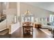 Elegant dining area with a large wooden table, chandelier, and lots of natural light at 7636 Sudan Ct, Las Vegas, NV 89149
