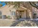 Inviting front entrance with a cozy porch, well-maintained landscaping, and a modern AC unit at 7636 Sudan Ct, Las Vegas, NV 89149
