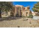 Charming two-story home with a classic stucco exterior and a well-maintained gravel front yard at 7636 Sudan Ct, Las Vegas, NV 89149
