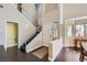 Welcoming foyer featuring hardwood floors, a staircase, and lots of natural light from nearby windows at 7636 Sudan Ct, Las Vegas, NV 89149