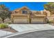 Spacious two-car garage with a wide driveway and beautiful desert landscaping at 7636 Sudan Ct, Las Vegas, NV 89149