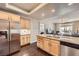 Bright eat-in kitchen featuring stainless steel appliances, granite countertops, and wood floors at 7636 Sudan Ct, Las Vegas, NV 89149