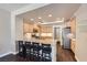 Modern kitchen with granite countertops, stainless steel appliances, and barstool seating for casual dining at 7636 Sudan Ct, Las Vegas, NV 89149