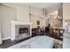 Spacious living room with a fireplace, open floor plan, and adjacent dining area, perfect for entertaining at 7636 Sudan Ct, Las Vegas, NV 89149