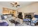 Spacious living room boasts a fireplace, ceiling fan, and access to the kitchen at 7636 Sudan Ct, Las Vegas, NV 89149