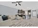 Open-concept living room with a ceiling fan seamlessly connected to the kitchen area at 788 Grand Country Ave, North Las Vegas, NV 89086
