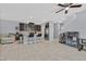 Open-concept kitchen and living area with stainless appliances, island seating, and tile floors at 788 Grand Country Ave, North Las Vegas, NV 89086