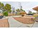 Backyard featuring a fenced pool, tiki umbrella, patio furniture, and a large gravel area at 8504 Soneto Ln, Las Vegas, NV 89117