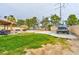 Backyard with covered patio, tiki umbrella, and fenced pool with gravel and grassy landscaping at 8504 Soneto Ln, Las Vegas, NV 89117