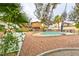 Landscaped backyard featuring a fenced pool, patio furniture, and partial home view at 8504 Soneto Ln, Las Vegas, NV 89117