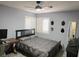 Bedroom showcasing a comfortable bed, ceiling fan, and windows with modern window coverings at 8504 Soneto Ln, Las Vegas, NV 89117