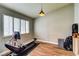 Light-filled bedroom with wood floors and a rowing machine, perfect for a home gym at 8504 Soneto Ln, Las Vegas, NV 89117