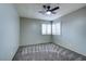 Neutral bedroom featuring carpeted floors, a ceiling fan and plantation shutters at 8504 Soneto Ln, Las Vegas, NV 89117