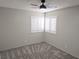 Vacant bedroom featuring fresh gray carpet, neutral paint, and a ceiling fan at 8504 Soneto Ln, Las Vegas, NV 89117