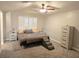 A neutral toned bedroom with shuttered windows and ceiling fan at 8504 Soneto Ln, Las Vegas, NV 89117