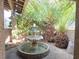 Charming courtyard featuring a decorative water fountain and ambient string lights creating a peaceful retreat at 8504 Soneto Ln, Las Vegas, NV 89117