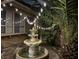 Charming courtyard featuring a decorative water fountain and ambient string lights creating a peaceful retreat at night at 8504 Soneto Ln, Las Vegas, NV 89117
