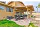 Covered patio with outdoor dining area and grill. Also, includes views of the lawn and garden at 8504 Soneto Ln, Las Vegas, NV 89117