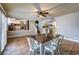 Bright dining room with view into the kitchen, tile floors, and a modern ceiling fan at 8504 Soneto Ln, Las Vegas, NV 89117