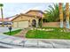 Charming single-story home with three-car garage, desert landscaping and American flag at 8504 Soneto Ln, Las Vegas, NV 89117