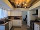 Well-lit kitchen with custom wood ceiling, white cabinets, and modern appliances for culinary adventures at 8504 Soneto Ln, Las Vegas, NV 89117
