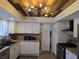 Charming kitchen with custom wood ceiling, white cabinetry, tile backsplash, and stainless steel appliances at 8504 Soneto Ln, Las Vegas, NV 89117