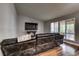 Spacious living room features hardwood flooring, wall-mounted TV, and shuttered windows at 8504 Soneto Ln, Las Vegas, NV 89117