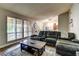 Comfortable living room offers a plush sofa, large windows, and hardwood flooring at 8504 Soneto Ln, Las Vegas, NV 89117