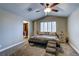 Neutral main bedroom featuring a ceiling fan, carpeted floors, walk-in closet and plantation shutters at 8504 Soneto Ln, Las Vegas, NV 89117