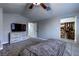 Carpeted Main bedroom featuring a ceiling fan, TV and walk-in closet at 8504 Soneto Ln, Las Vegas, NV 89117