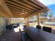 Outdoor covered patio, featuring fan, table and seating, and a view of the pool at 8504 Soneto Ln, Las Vegas, NV 89117