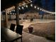 Enjoy a relaxing evening in the backyard with a tiki hut and string lights around the pool at 8504 Soneto Ln, Las Vegas, NV 89117