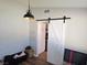 Functional storage area with barn door leading to the kitchen, and modern overhead lighting at 8504 Soneto Ln, Las Vegas, NV 89117