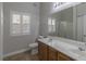 Bright bathroom with dual sink vanity, toilet and a shower-tub combo with a window at 8805 Jeffreys St # 1018, Las Vegas, NV 89123