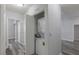 Hallway with stackable washer and dryer nestled in a closet with bi-fold doors and gray plank flooring at 8805 Jeffreys St # 1018, Las Vegas, NV 89123