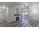 Bright living room featuring gray wood floors, a fireplace, and sliding door access to a patio at 8805 Jeffreys St # 1018, Las Vegas, NV 89123