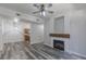 Cozy living room with wood flooring, fireplace and ceiling fan with exposed kitchen area at 8805 Jeffreys St # 1018, Las Vegas, NV 89123