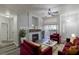 Inviting living room with a cozy fireplace, plush seating, and modern ceiling fan at 8805 Jeffreys St # 1018, Las Vegas, NV 89123