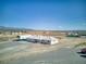 Aerial view of a detached home with a large lot, metal building, and mountain views in the distance at 881 W Kathryn Ave, Pahrump, NV 89060
