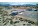 An aerial shot of a home with mountain views, a metal building, and natural desert landscaping at 881 W Kathryn Ave, Pahrump, NV 89060
