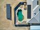 Top-down view of in ground pool and spa, solar panels and home with white tile roof at 881 W Kathryn Ave, Pahrump, NV 89060
