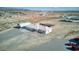 An aerial view of a detached home with a large lot, metal building, and multiple cars in the driveway at 881 W Kathryn Ave, Pahrump, NV 89060