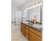 Bright bathroom featuring a double sink vanity with granite countertop and oak cabinets at 881 W Kathryn Ave, Pahrump, NV 89060